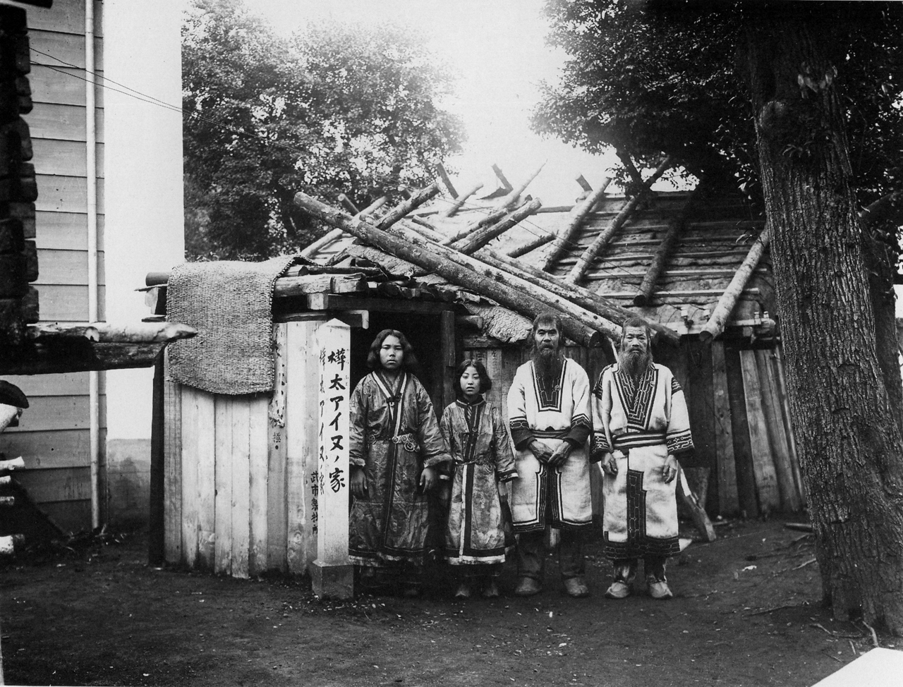A Sakhalin Ainu dwelling and four occupants, photographed in 1912